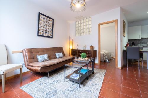 a living room with a couch and a table at Host Wise - Stylish Adorable Flat in Gaia in Vila Nova de Gaia