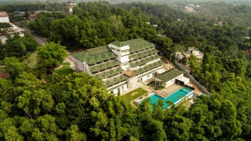 an aerial view of a building in the forest at Avoki Resorts in Trivandrum
