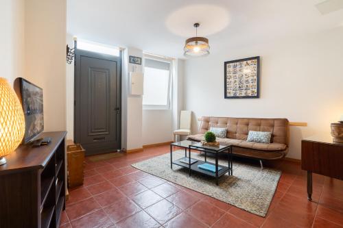 a living room with a couch and a table at Host Wise - Stylish Adorable Flat in Gaia in Vila Nova de Gaia