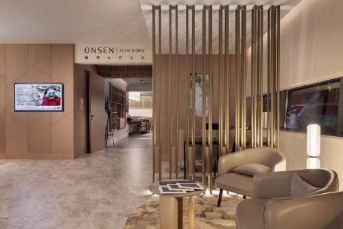 a lobby with a couch and a chair in a building at Marine Hotel by Zdrojowa in Kołobrzeg