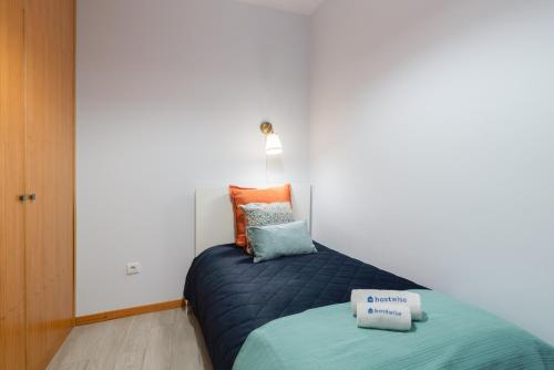 a bedroom with a bed with two pillows on it at Host Wise - Stylish Adorable Flat in Gaia in Vila Nova de Gaia