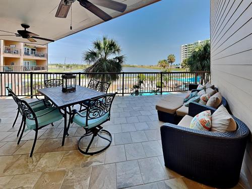 a patio with a table and a couch at Maravilla 146-sea Ya Next Tide in Galveston
