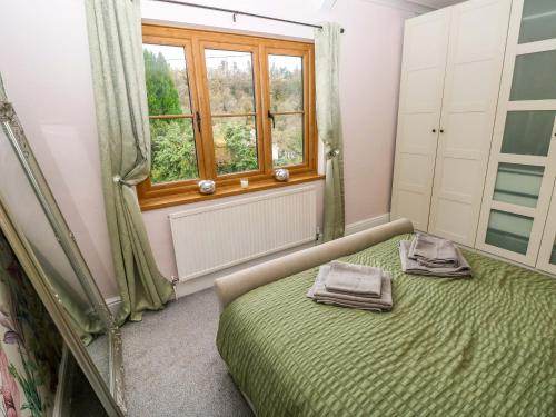 a bedroom with a bed and a window at 100 Cwmphil Road in Swansea