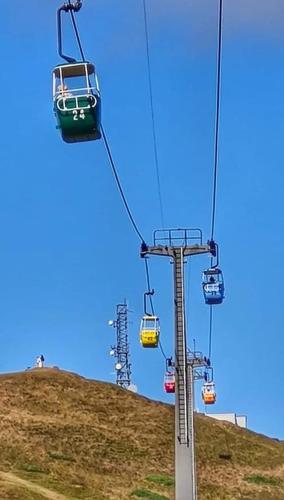 a ski lift with several chairs on a hill at Bron Orme Private Hotel in Llandudno