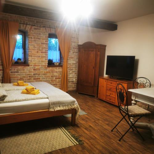 a bedroom with a bed and a flat screen tv at Kúria Apartman Private Wellness in Budapest