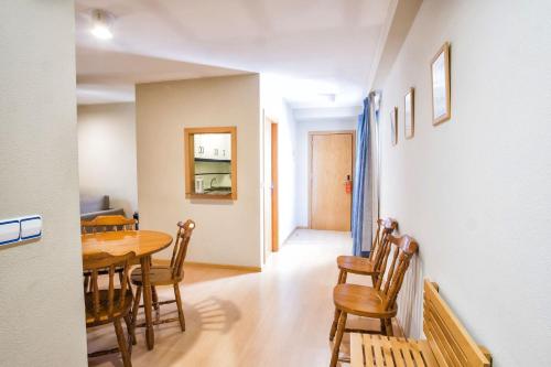 a kitchen and dining room with a table and chairs at Hotel Alda Castelao in Vilagarcia de Arousa