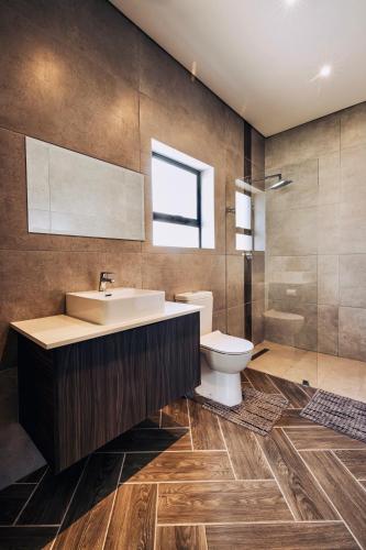 a bathroom with a sink and a toilet at Phoenix Home in Cape Town