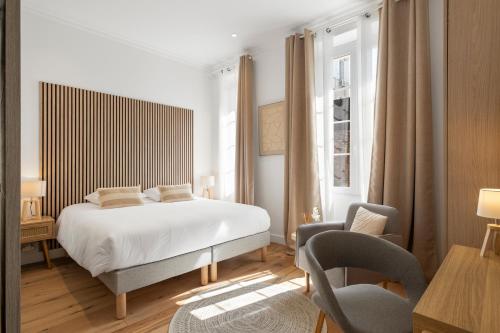 une chambre avec un lit, un bureau et une chaise dans l'établissement Cannes heart, 3 BR, 3 Bath, 100m Palais & beach, à Cannes