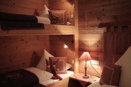 a room with two bunk beds and a lamp at Chalet Tannenhof in Lermoos