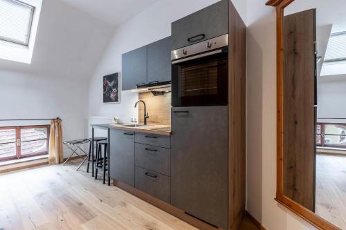 a kitchen with a stainless steel refrigerator and a counter at Apartments am Schloss Mühldorf in Feldkirchen an der Donau