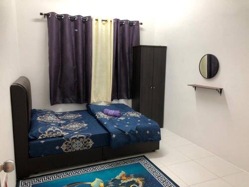 a bedroom with a blue bed and a window at SK Villa's Homestay Kota Warisan, Dengkil, KLIA in Sepang