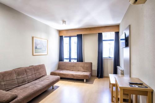 a living room with a couch and a table at Hotel Alda Castelao in Vilagarcia de Arousa