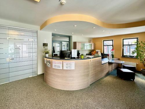 a lobby with a counter with a reception desk at Evangelisches Allianzhaus in Bad Blankenburg
