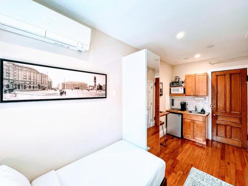 a room with a bed and a picture on the wall at Copley House in Boston
