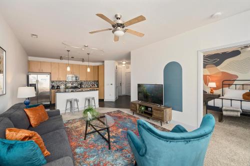 a living room with a couch and a table at League Flats South End on South College Street in Charlotte