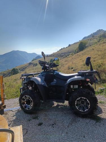 a black atv parked on the side of a hill at Dream view of Apuseni in Rîmeţi