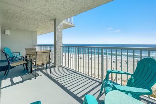 a balcony with chairs and a view of the beach at Romar Tower Unit 8C in Orange Beach