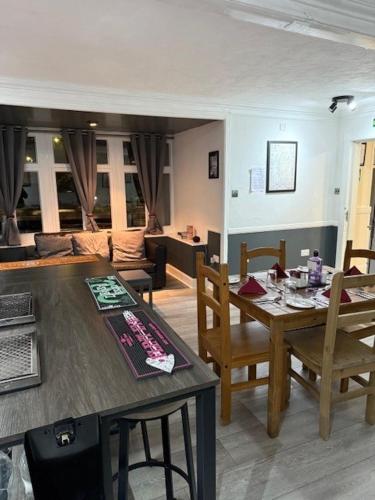 a living room with a wooden table and chairs at Novar Arms Hotel in Evanton