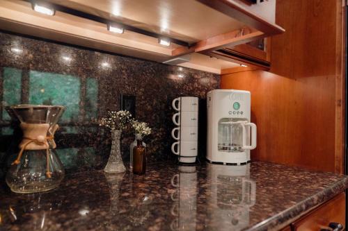 a kitchen counter with a coffee maker on a counter top at Luxury House, Walk to Downtown or Pioneer Park in Nevada City