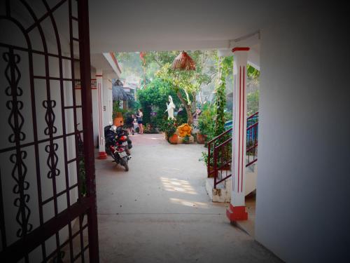 a person on a motorcycle parked in a hallway at Happy Family Guesthouse in Vĩnh Long