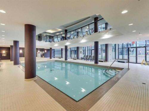 a large swimming pool in a large building at Downtown Toronto Condo Parking Sleeps 4 Balcony Walk to Lake in Toronto