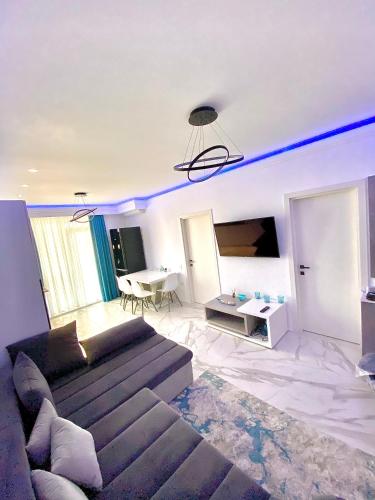 a living room with a couch and a table at Summerland Seaview Apartments in Mamaia