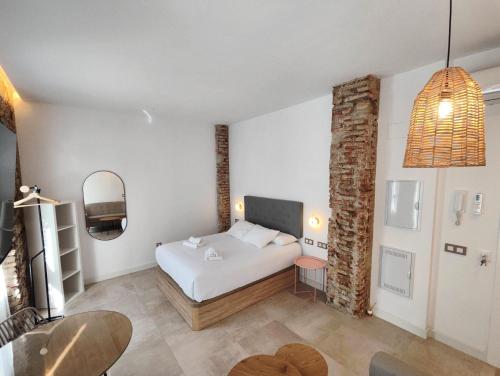a bedroom with a white bed in a room at La estación in Málaga