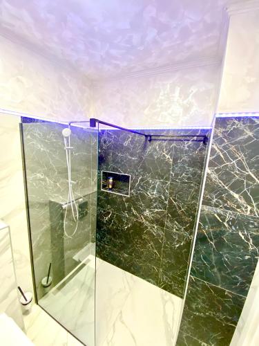 a shower with a glass door in a bathroom at Summerland Seaview Apartments in Mamaia