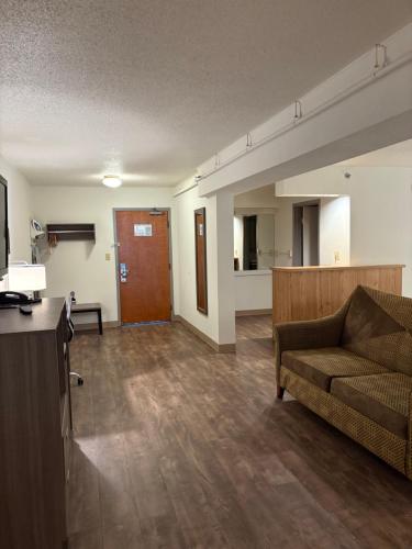 a living room with a couch and a door at Clarion Inn & Suites and Convention Center in Kearney
