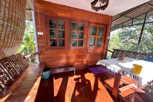 a dining room with a table and two chairs at Baansuan Chomchun in Amphoe Mae Taeng