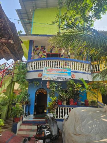 a house with a motorcycle parked in front of it at Advait Holiday Home in Nagaon
