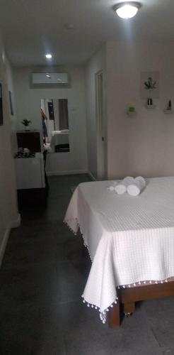 a bedroom with a white bed with towels on it at Point Gate Inn in Bacolod