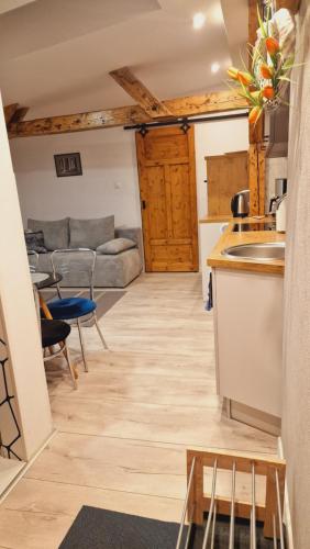 a kitchen and living room with a couch and a table at Kamienica "Pod dębem" in Lidzbark Warmiński