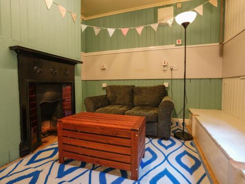 a living room with a couch and a coffee table at YHA Hawkshead in Hawkshead