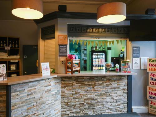 a bar in a store with a brick counter at YHA Hawkshead in Hawkshead