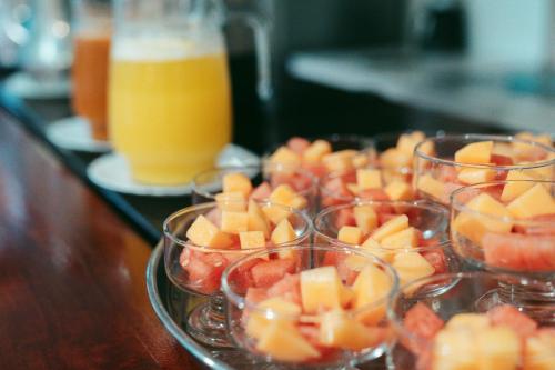 a tray of fruit in cups on a table at Fernandina Hotel & Spa in Puerto Ayora
