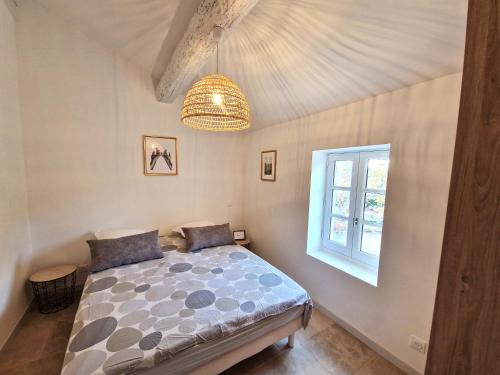 a bedroom with a bed and a window at Sadi Carnot in Arles