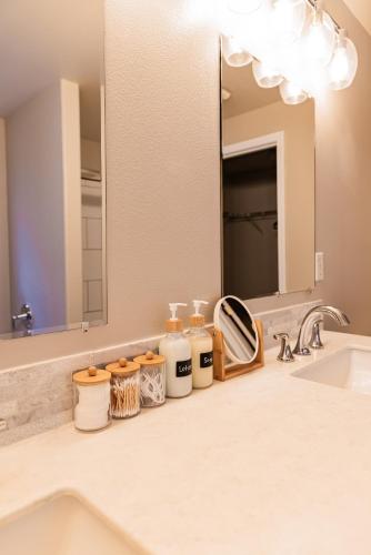 a bathroom counter with a sink and a mirror at Backyard hot tub for your family in Vancouver