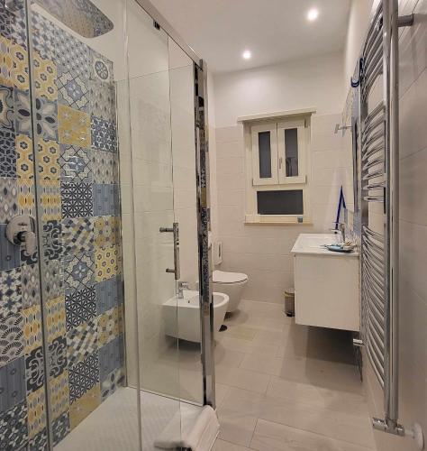 a bathroom with a shower and a toilet and a sink at Villa Zefiro - Suites & Events in Battipaglia