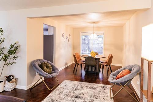 a dining room with chairs and a table at Backyard hot tub for your family in Vancouver