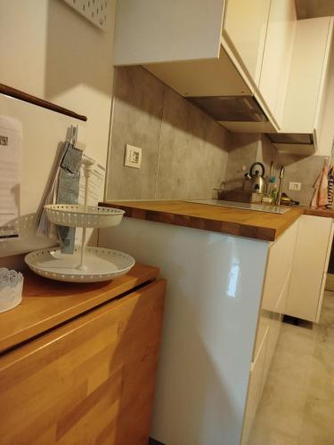 a kitchen with white cabinets and a counter top at dalla nonna Paola in Robbiate