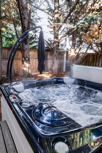 a sink with a faucet in a yard at Backyard hot tub for your family in Vancouver