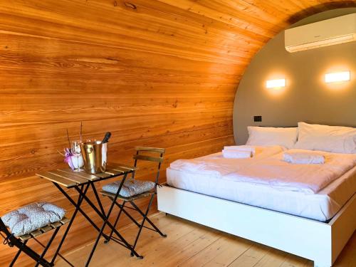 a bedroom with a bed and a table with chairs at Borgo Terra village in Fagagna