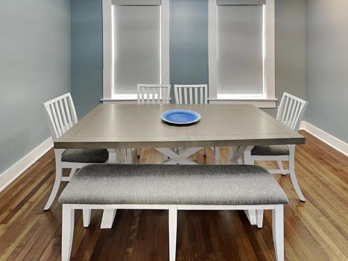 a dining room table with chairs and a blue plate on it at Blue Lagoon in Galveston
