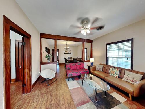 a living room with a couch and a ceiling fan at Hidden Haven in Galveston