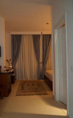 a bedroom with a bed and a window at Elaria Hotel Hurgada in Hurghada
