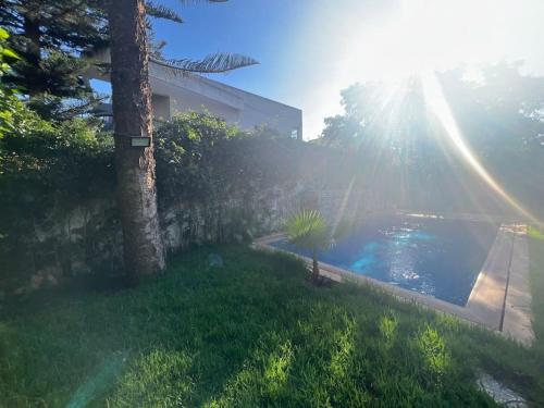 a view of a yard with a swimming pool at Villa Lalla Laroussa in Kenitra