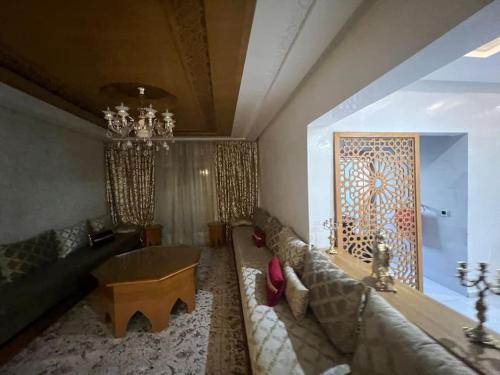 a living room with a couch and a table at Villa Lalla Laroussa in Kenitra