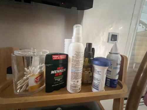 a wooden shelf with several bottles of hair products on it at Villa Lalla Laroussa in Kenitra