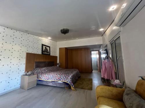 a large bedroom with a bed and a couch at Villa Lalla Laroussa in Kenitra